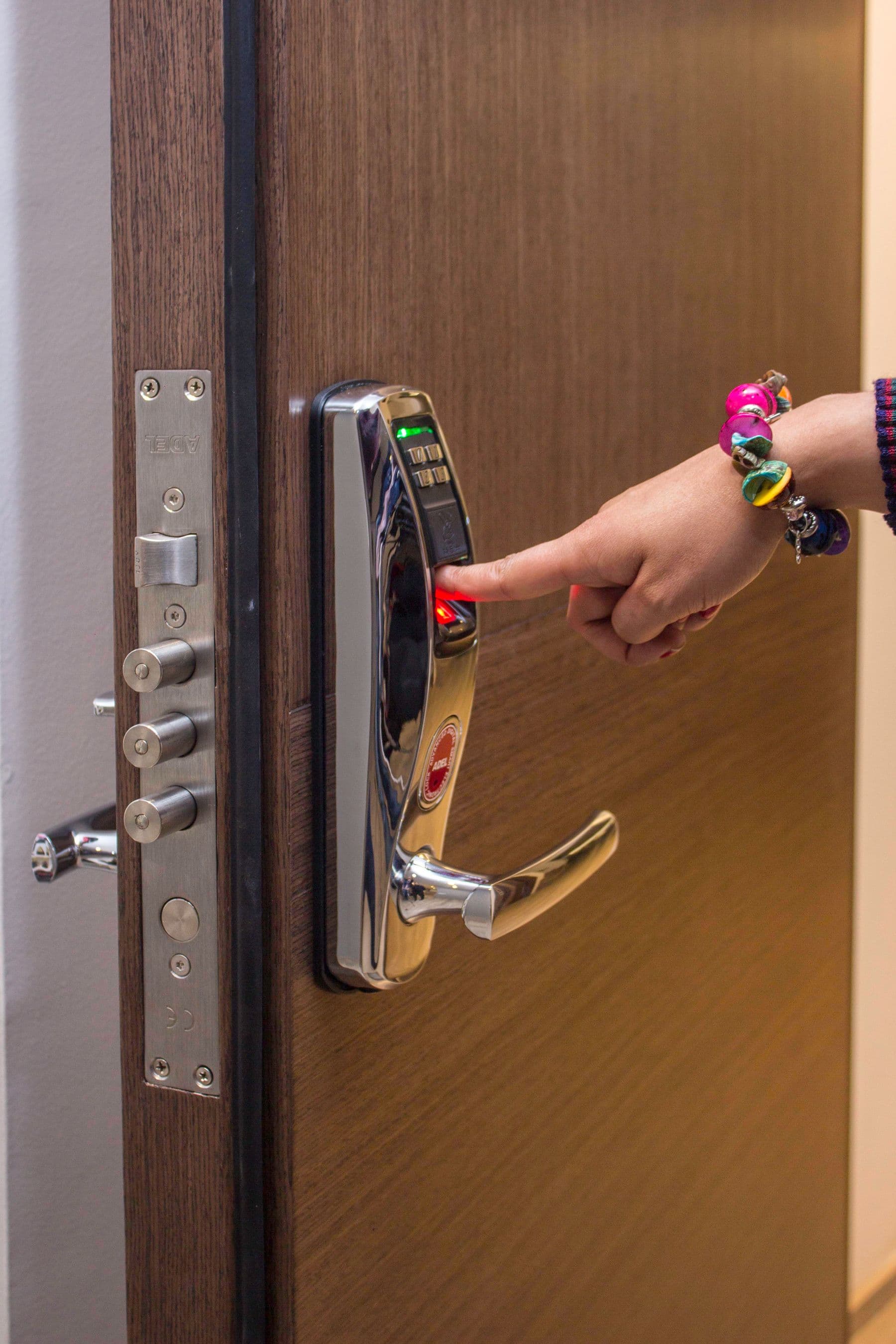 A person using a fingerprint access-control reader