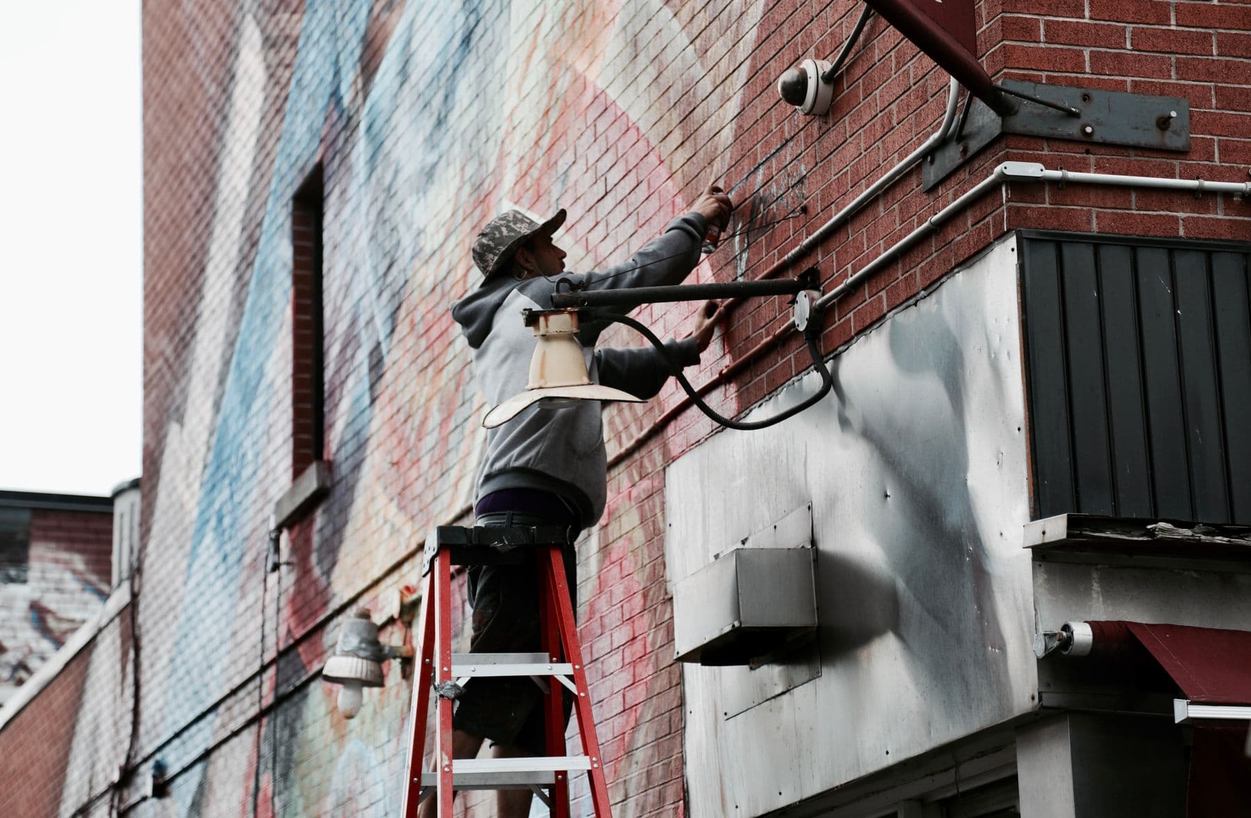 A technician installing a CCTV camera at a property